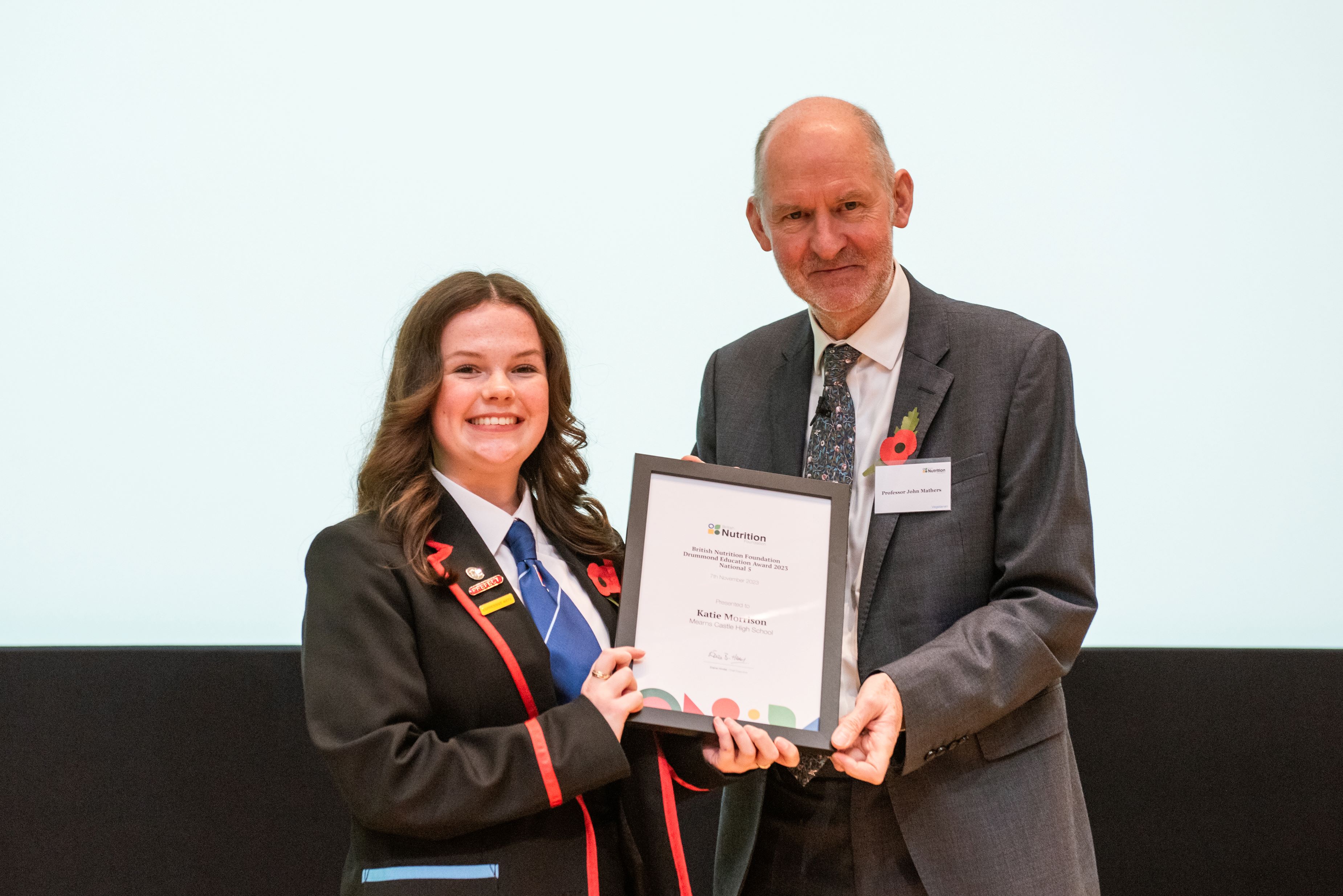A photo of a pupil receiving her award at the BNF Annual Conference loading=
